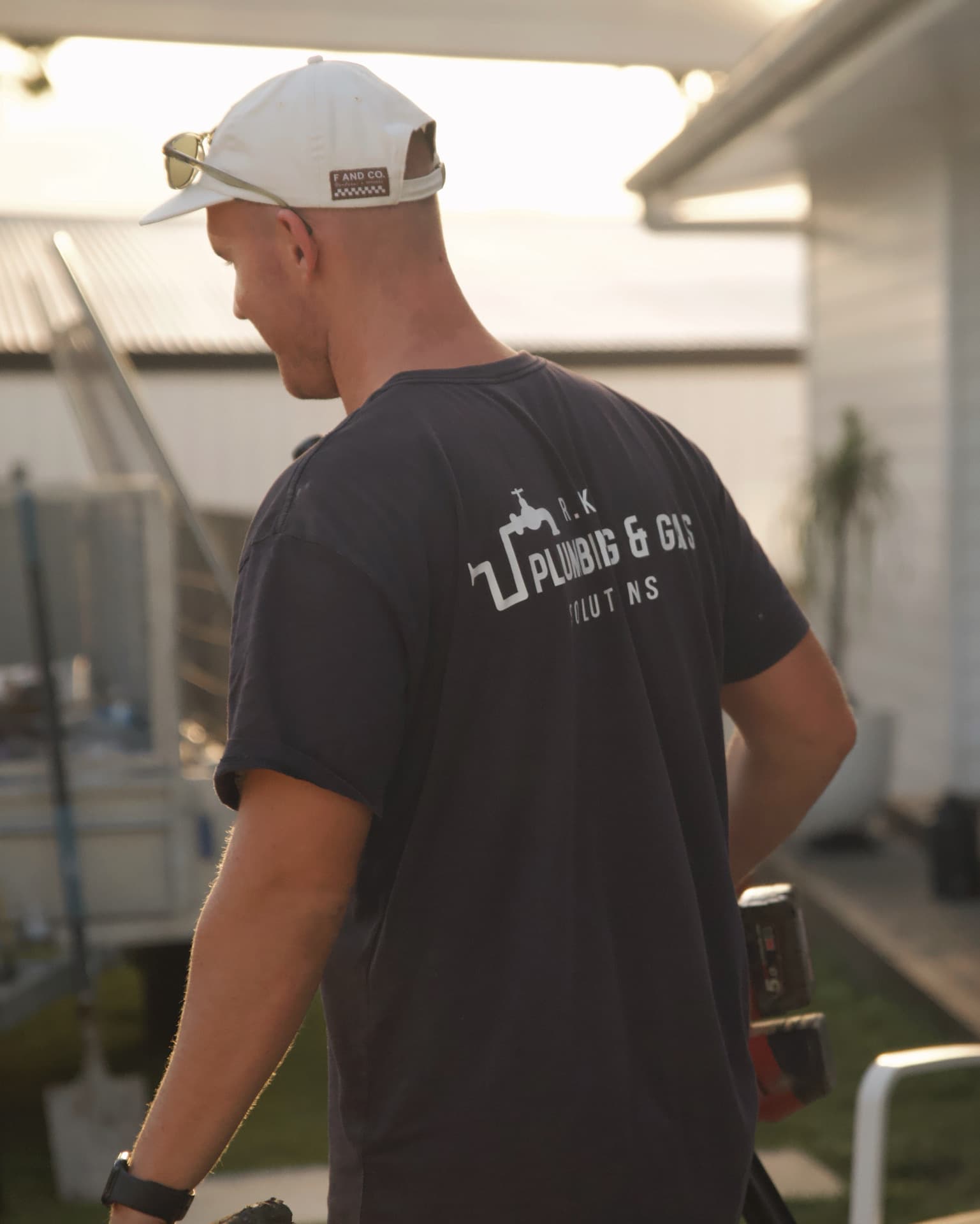 RK Plumbing & Gas plumber in uniform on site at a Sunshine Coast home.